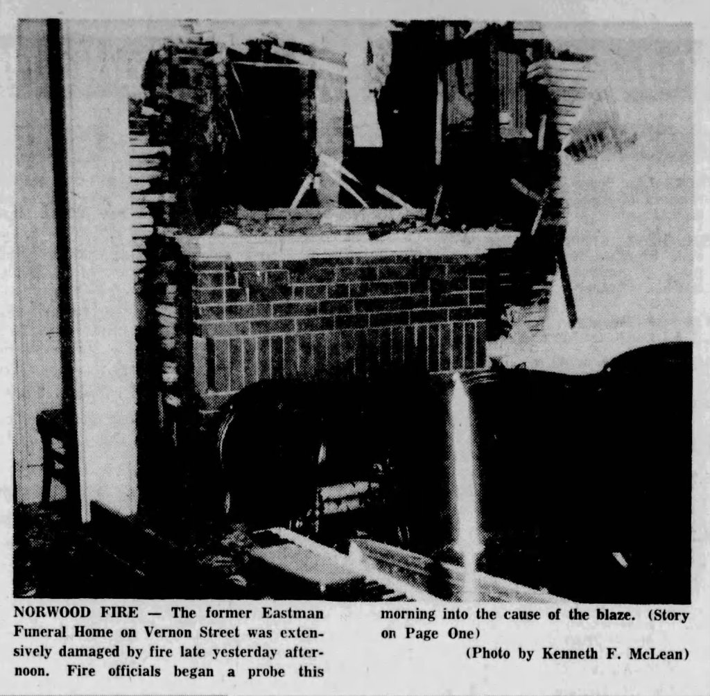 Image of a fire-damaged interior of the former Eastman Funeral Home on Vernon Street, showing extensive structural damage and debris.