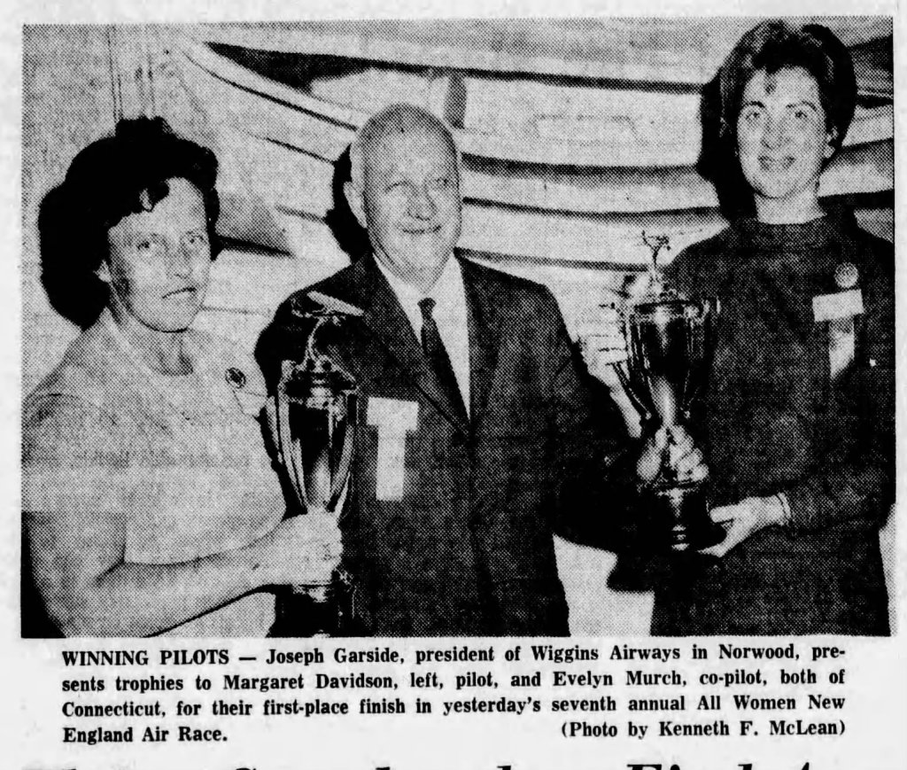 Joseph Garside, president of Wiggins Airways, presents trophies to pilots Margaret Davidson and Evelyn Murch for their first-place finish in the All Women New England Air Race.