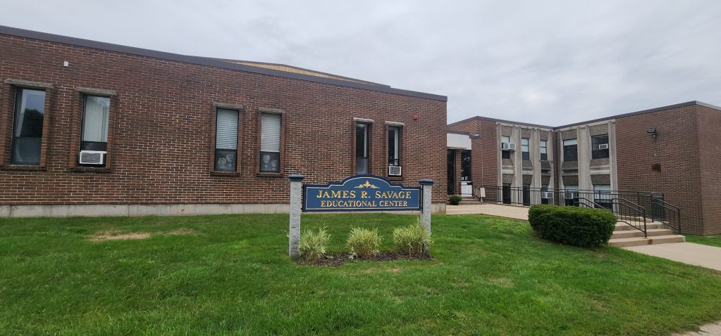 Exterior view of the James R. Savage Educational Center, showcasing the brick building and entrance pathways.