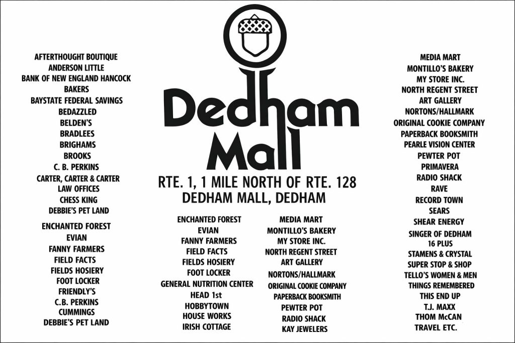 A directory sign listing various shops and services at Dedham Mall, including retail stores, bakeries, and dining options, located on Route 1, one mile north of Route 128 in Dedham.