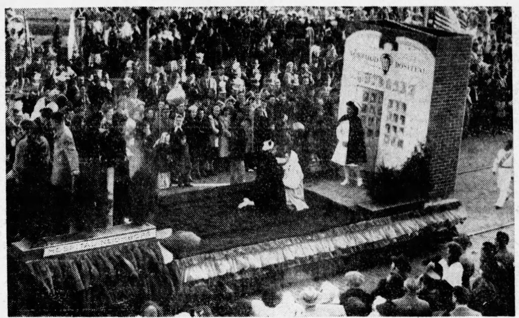 HOSPITAL FLOAT IN NORWOOD PARADE—Nurses “administer to sick” on float of Norwood Hospital during 75th Anniversary Parade yesterday