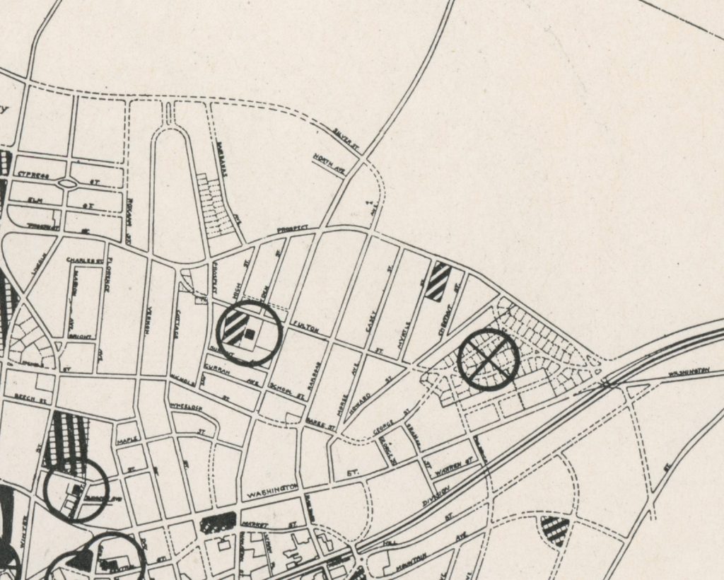Detailed black and white map showing streets and circular patterns, with identified locations and grid layout.