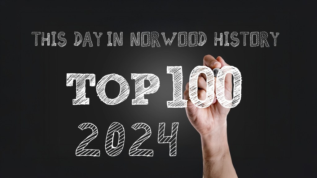 A hand holding a number '100' with the text 'THIS DAY IN NORWOOD HISTORY TOP 100 2024' in a stylized font on a dark background.