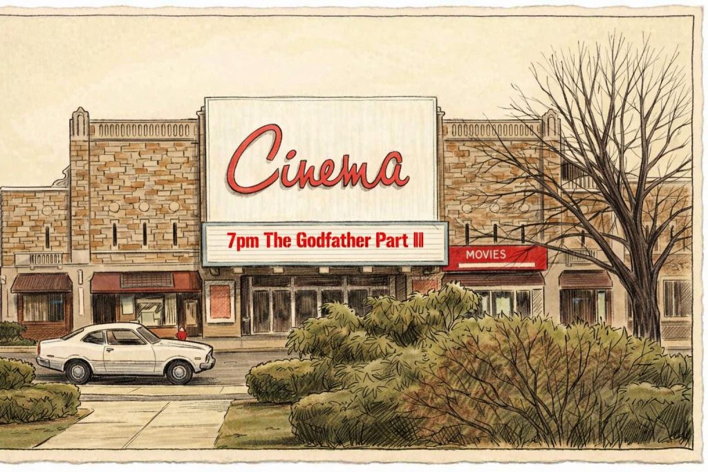 A vintage cinema building with a marquee displaying '7pm The Godfather Part III'. A white car is parked in front, with shrubs and trees surrounding the entrance.