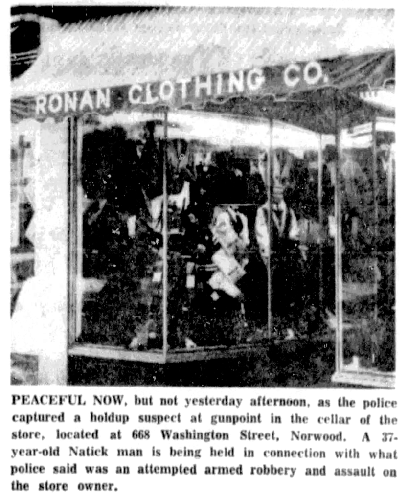 A storefront of Ronan Clothing Co., featuring clothing displays in the window and a notice about a recent robbery incident.