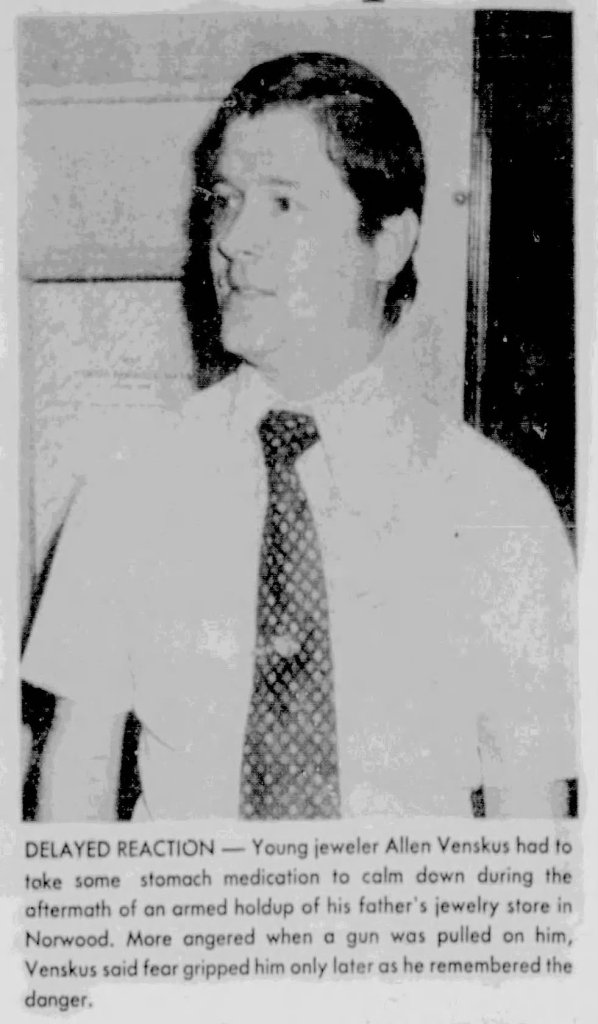 Young jeweler Allen Venskus, wearing a white shirt and patterned tie, looks concerned while recounting a traumatic experience following an armed robbery at his father's jewelry store.